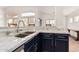 Modern kitchen with stainless steel appliances, granite countertops, and stylish navy blue cabinets at 6965 E Hacienda La Noria Ln, Gold Canyon, AZ 85118