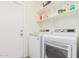 Convenient laundry room featuring a washer, dryer, and shelving for supplies at 6965 E Hacienda La Noria Ln, Gold Canyon, AZ 85118