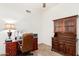 Traditional office setup showcases a wooden desk and built-in hutch for ample storage at 6965 E Hacienda La Noria Ln, Gold Canyon, AZ 85118