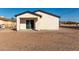 Rear exterior of home with sliding glass door to covered patio at 700 N D St, Eloy, AZ 85131