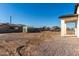 Unfinished backyard of a home with a gravel and dirt surface and chain link fence at 700 N D St, Eloy, AZ 85131