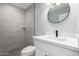 Updated bathroom with a modern vanity, sleek mirror, and tiled walk-in shower at 700 N D St, Eloy, AZ 85131
