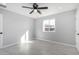 Bright bedroom featuring neutral colors, a modern ceiling fan, and a view from the large window at 700 N D St, Eloy, AZ 85131