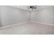 A light-filled bedroom with tile floors, neutral walls, and a ceiling fan at 700 N D St, Eloy, AZ 85131