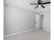 Neutral bedroom featuring a modern ceiling fan and doorway to an adjoining room at 700 N D St, Eloy, AZ 85131