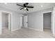 Spacious bedroom with neutral walls, modern ceiling fan, and two open doorways at 700 N D St, Eloy, AZ 85131