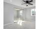 Sunlit bedroom with a ceiling fan, mirrored closet, and a window offering neighborhood views at 700 N D St, Eloy, AZ 85131