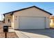 Home's exterior with a wide garage door, front door to the left, and house number to the left of the garage at 700 N D St, Eloy, AZ 85131
