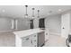 Kitchen island with sleek white countertop and stainless steel dishwasher at 700 N D St, Eloy, AZ 85131