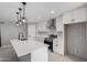 The kitchen features modern appliances, white cabinetry, sleek countertops, and modern lighting at 700 N D St, Eloy, AZ 85131