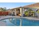 Backyard with a shimmering pool, covered patio and desert landscaping at 9 W Glenhaven Dr, Phoenix, AZ 85045
