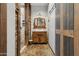 Farmhouse-style bathroom with stone floors, a stone shower, and wooden accents at 9 W Glenhaven Dr, Phoenix, AZ 85045