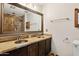 Bathroom with double sink vanity and stone-lined shower featuring mosaic pebble design at 9 W Glenhaven Dr, Phoenix, AZ 85045