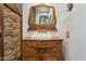 Bathroom vanity featuring a vessel sink, rustic wood, and a decorative mirror at 9 W Glenhaven Dr, Phoenix, AZ 85045