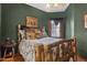 Rustic bedroom featuring log bed frame and lodge-themed decor and an earthy green paint at 9 W Glenhaven Dr, Phoenix, AZ 85045