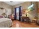Bedroom featuring a TV, a desk, natural light, and neutral colors at 9 W Glenhaven Dr, Phoenix, AZ 85045