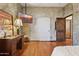 Bedroom featuring hardwood floors, a TV, neutral paint, and a rustic wooden door at 9 W Glenhaven Dr, Phoenix, AZ 85045