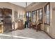 Bright dining area featuring tiled floors, a corner bar, and ample natural light at 9 W Glenhaven Dr, Phoenix, AZ 85045