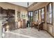 Bright dining area featuring tiled floors, a corner bar, and ample natural light at 9 W Glenhaven Dr, Phoenix, AZ 85045