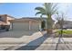 Desert home featuring a large three-car garage and drought-resistant landscaping at 9 W Glenhaven Dr, Phoenix, AZ 85045