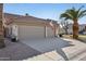 Spacious three-car garage with ample driveway parking, set against a desert landscape at 9 W Glenhaven Dr, Phoenix, AZ 85045