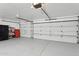 Organized three-car garage with ample storage space and clean epoxy flooring at 9 W Glenhaven Dr, Phoenix, AZ 85045