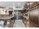 Well-lit kitchen with stainless steel appliances and dark wood cabinetry at 9 W Glenhaven Dr, Phoenix, AZ 85045