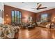 Inviting living room featuring a hardwood floor, cozy seating, and a ceiling fan at 9 W Glenhaven Dr, Phoenix, AZ 85045