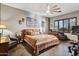 Spacious main bedroom with a ceiling fan, large window, and classic decor at 9 W Glenhaven Dr, Phoenix, AZ 85045