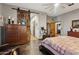 Bright main bedroom featuring a wooden barn door, a stationary bike, and neutral paint colors at 9 W Glenhaven Dr, Phoenix, AZ 85045