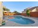 Backyard swimming pool with surrounding patio and lush landscaping at 9 W Glenhaven Dr, Phoenix, AZ 85045