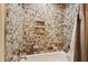 Modern shower features beautiful custom stone mosaic and tiled niche for toiletries at 9 W Glenhaven Dr, Phoenix, AZ 85045