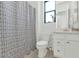 Bathroom featuring a shower with patterned curtain and a single sink vanity with white cabinetry at 9422 S 7Th Pl, Phoenix, AZ 85042