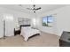 Large bedroom with neutral carpet, black ceiling fan, large picture window, and modern decor at 9422 S 7Th Pl, Phoenix, AZ 85042