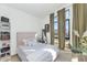 Bright bedroom featuring neutral walls, carpet, modern window treatments and decor at 9422 S 7Th Pl, Phoenix, AZ 85042