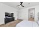 Bright bedroom featuring neutral carpet, black ceiling fan and an ensuite bathroom at 9422 S 7Th Pl, Phoenix, AZ 85042