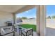 Covered patio featuring neutral-toned chairs and table, grill, and an artificial turf backyard with mountain views at 9422 S 7Th Pl, Phoenix, AZ 85042