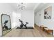 Bright exercise room with a stationary bike, free weights, a full-length mirror, and wood flooring at 9422 S 7Th Pl, Phoenix, AZ 85042
