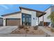 Charming modern home with a two car garage, desert landscaping, and a covered walkway to the front door at 9422 S 7Th Pl, Phoenix, AZ 85042