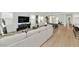 Airy open-concept design featuring a large sectional sofa, a stylish entertainment center, and wood flooring at 9422 S 7Th Pl, Phoenix, AZ 85042