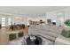 Spacious living area with modern furnishings, wood flooring, and an open layout that connects to the dining area at 9422 S 7Th Pl, Phoenix, AZ 85042