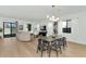 Open concept living space featuring modern furnishings, a formal dining area, wood floors, and a seamless flow at 9422 S 7Th Pl, Phoenix, AZ 85042