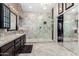 Stunning bathroom featuring a spacious glass shower, granite countertops, and a large walk-in closet at 9809 W Wescott Dr, Peoria, AZ 85382