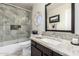 Bathroom with a modern shower-tub combo and a granite vanity at 9809 W Wescott Dr, Peoria, AZ 85382