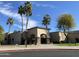 Clubhouse exterior features a covered entrance, desert landscaping, and palm trees at 9809 W Wescott Dr, Peoria, AZ 85382