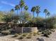 Stone sign for Westbrook Village amid desert landscaping and towering palm trees at 9809 W Wescott Dr, Peoria, AZ 85382