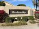 Meadowridge entrance sign with colorful flowers and manicured landscaping at 9809 W Wescott Dr, Peoria, AZ 85382