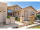 Charming home featuring desert landscaping, two-car garage, and arched window details at 9809 W Wescott Dr, Peoria, AZ 85382