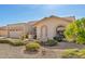 Inviting single-story home with desert landscaping, a two-car garage, and arched window details at 9809 W Wescott Dr, Peoria, AZ 85382