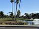 Scenic view of the golf course with a pond, fountain, and lush green fairways at 9809 W Wescott Dr, Peoria, AZ 85382